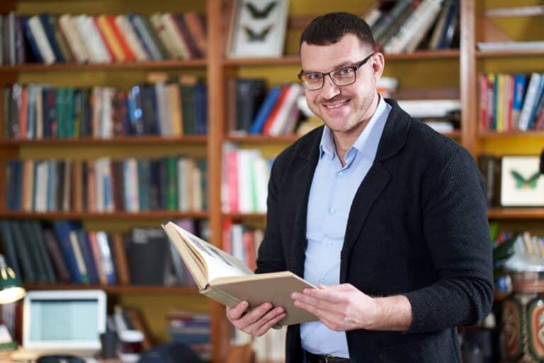 Man reading a book in the library
