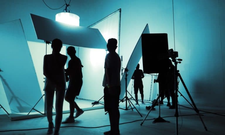 TV or movie director with production crew team setting up